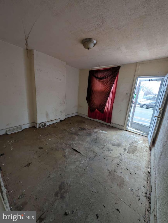 empty room with a textured ceiling