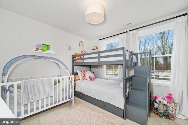 bedroom featuring carpet and multiple windows