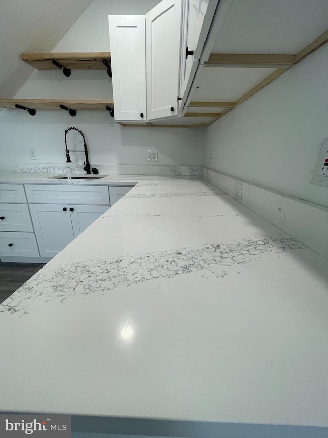 kitchen featuring sink and white cabinets