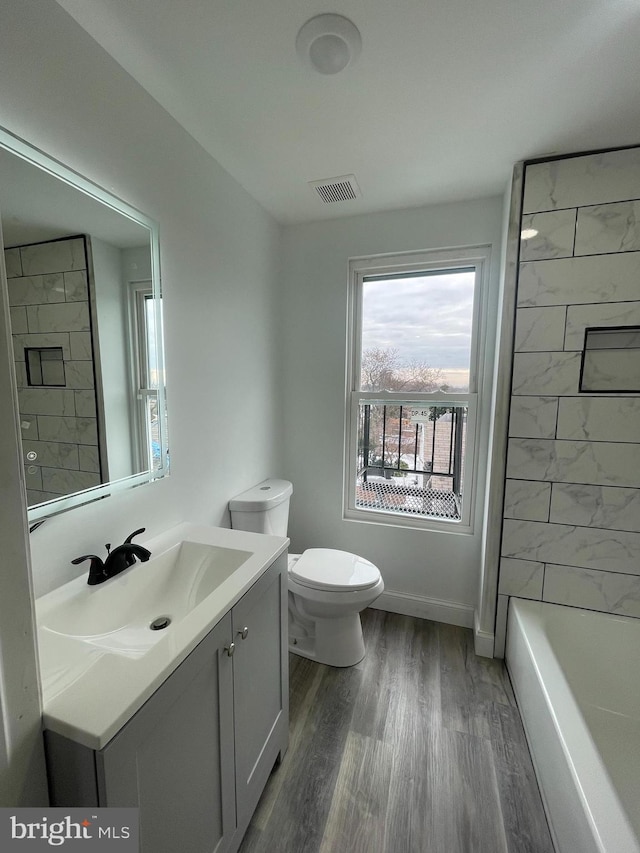 bathroom featuring hardwood / wood-style floors, vanity, and toilet