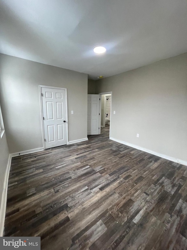 unfurnished bedroom featuring dark wood-type flooring