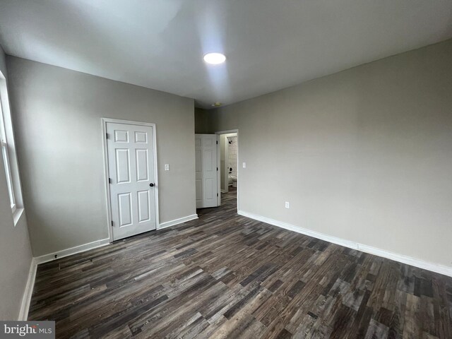 unfurnished bedroom featuring dark wood-type flooring