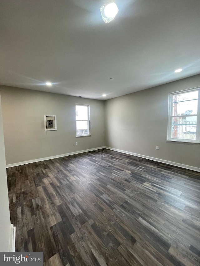 empty room featuring dark hardwood / wood-style flooring