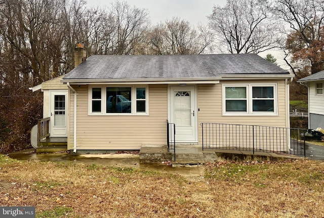 bungalow-style house featuring a front yard