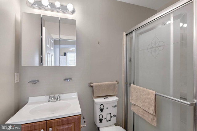 bathroom with walk in shower, vanity, and toilet