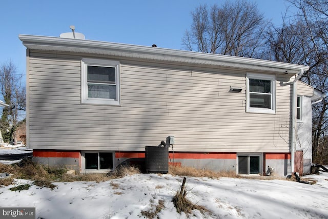 view of snowy exterior featuring central AC