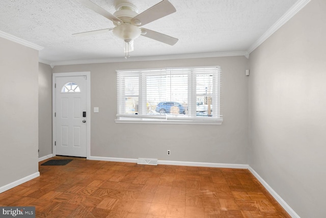 foyer featuring light parquet flooring, a textured ceiling, ceiling fan, and crown molding