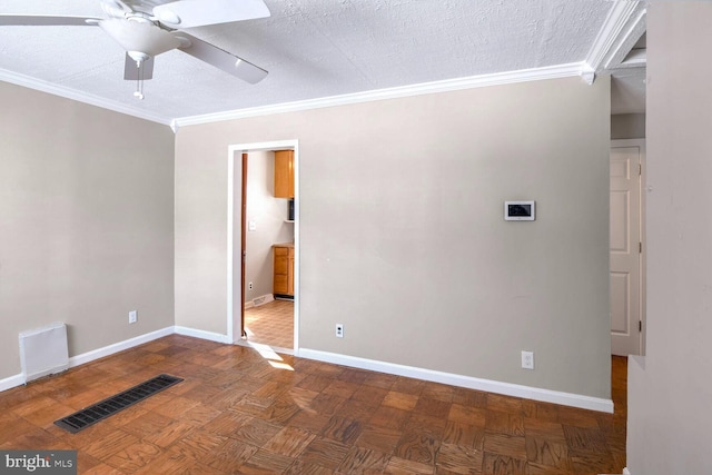 empty room featuring a textured ceiling, ceiling fan, crown molding, and parquet floors