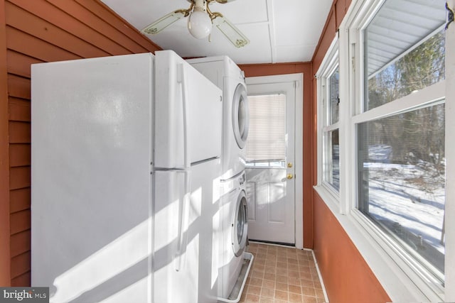 laundry area featuring ceiling fan and stacked washer / drying machine