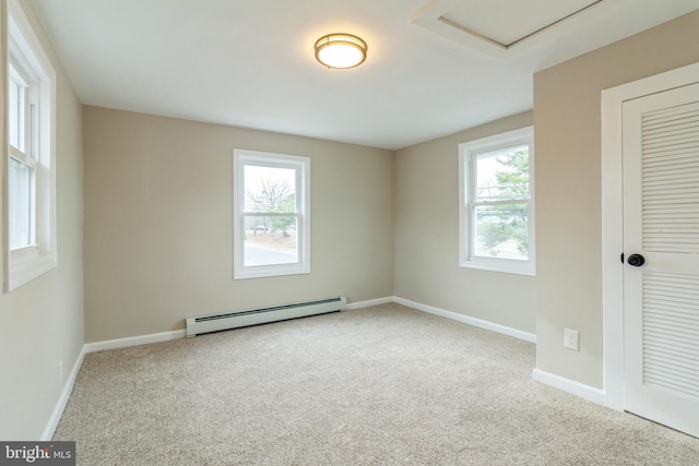 empty room with light carpet and a baseboard heating unit