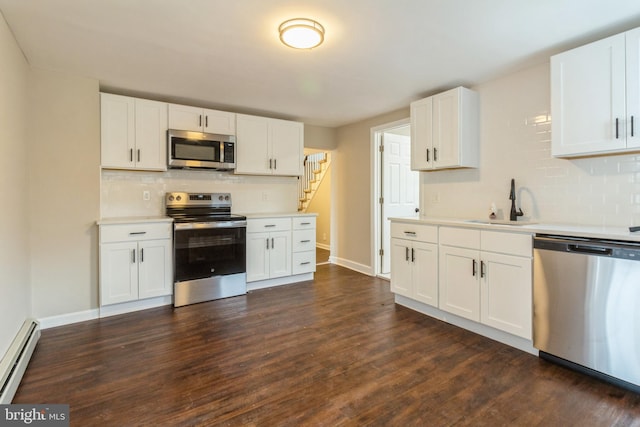 kitchen featuring white cabinetry, stainless steel appliances, and a baseboard radiator