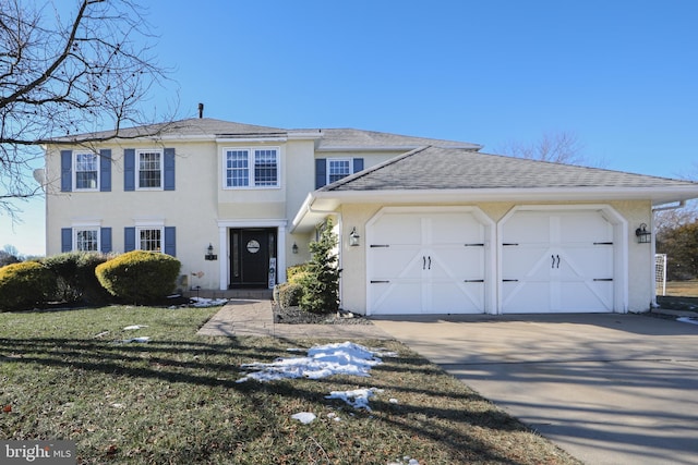 view of front of home featuring a front lawn and a garage