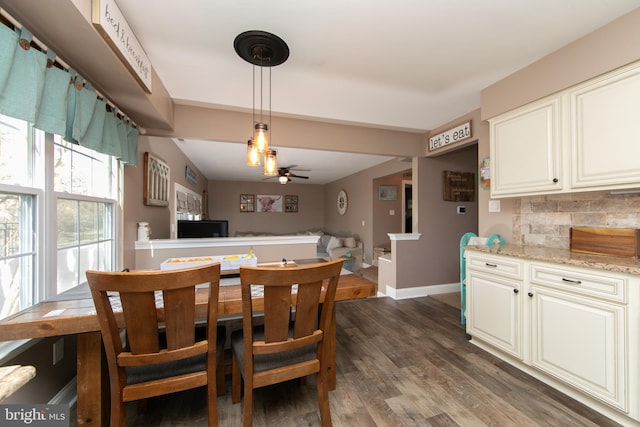 dining area with ceiling fan and dark wood-type flooring