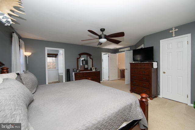 carpeted bedroom with ceiling fan and ensuite bathroom