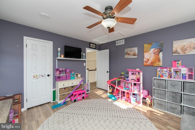 rec room featuring ceiling fan and light wood-type flooring