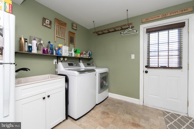 clothes washing area with sink and washing machine and dryer