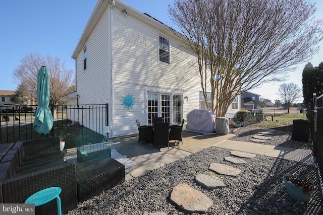 rear view of property featuring an outdoor hangout area and a patio