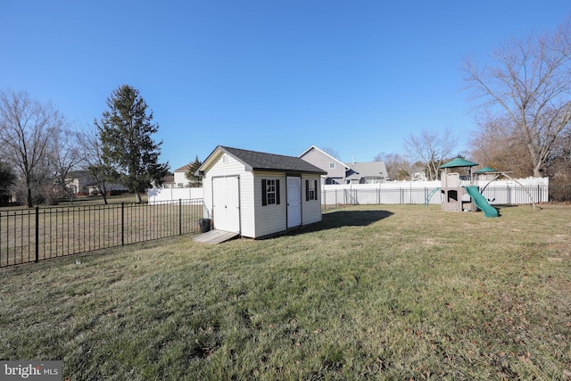 view of yard featuring a playground and a storage unit