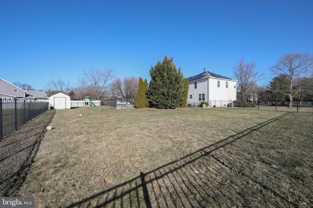 view of yard featuring a playground and a shed