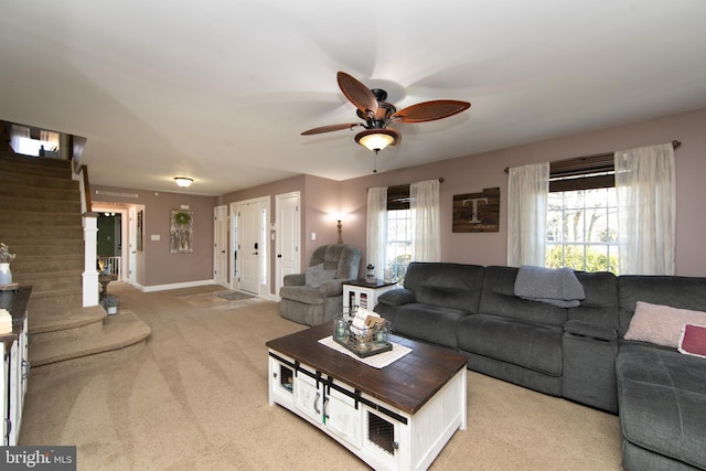 carpeted living room featuring ceiling fan