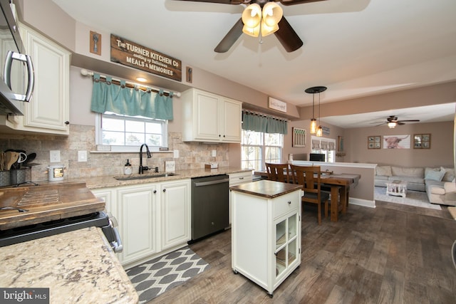 kitchen with appliances with stainless steel finishes, tasteful backsplash, white cabinetry, and sink