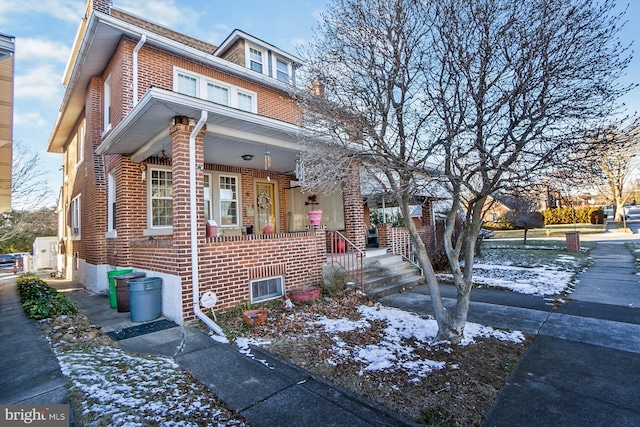 townhome / multi-family property featuring covered porch