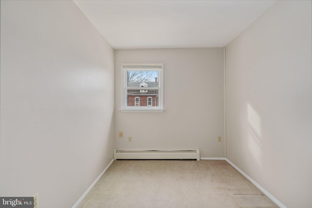 unfurnished room with light carpet and a baseboard heating unit