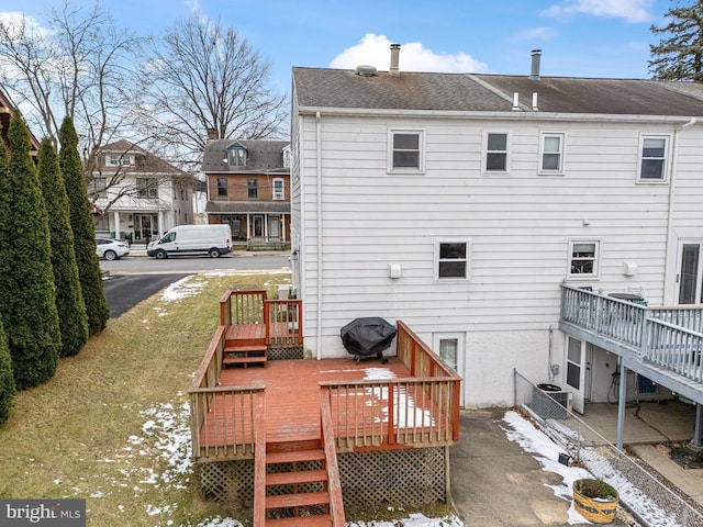 rear view of house with a deck and cooling unit