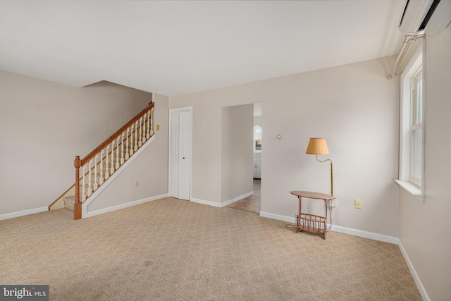 unfurnished living room featuring an AC wall unit and light colored carpet