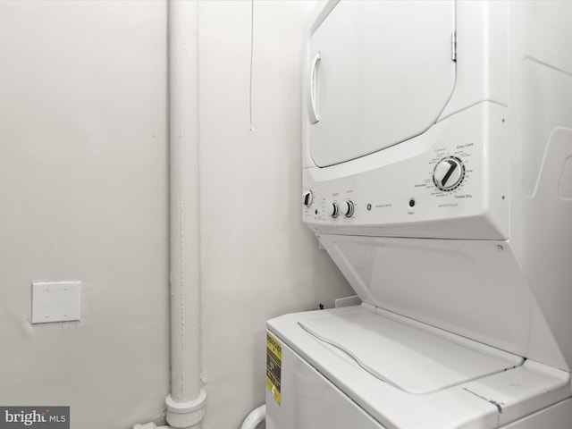 washroom featuring stacked washer / dryer