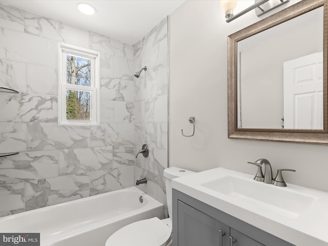 full bathroom featuring toilet, vanity, and tiled shower / bath combo