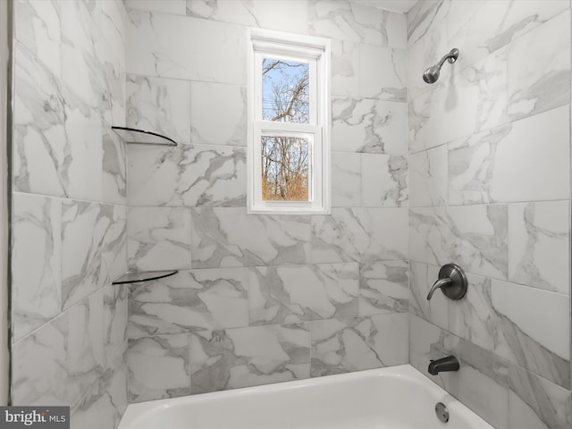 bathroom featuring tiled shower / bath combo and a healthy amount of sunlight