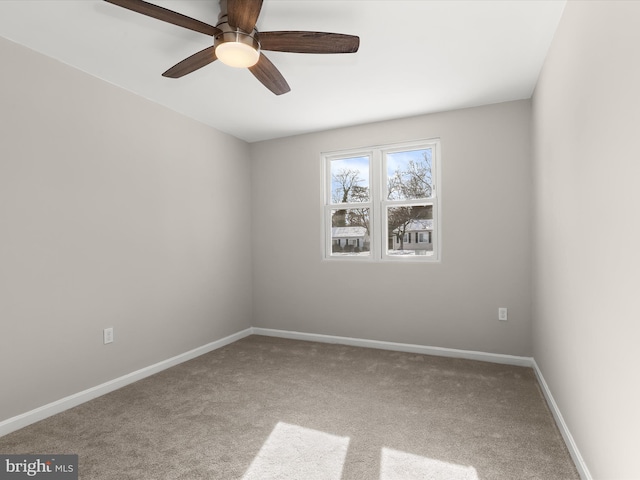 spare room with ceiling fan and carpet flooring