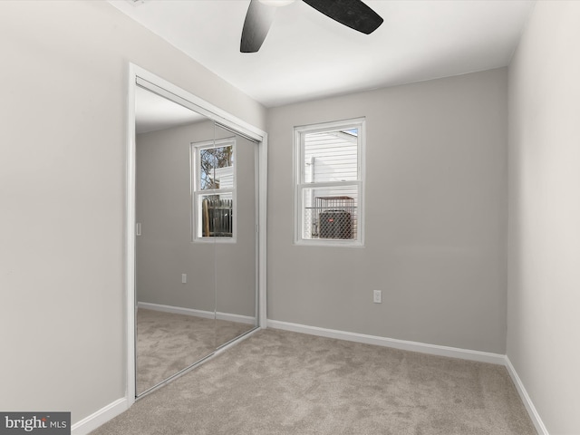 unfurnished bedroom with a closet, ceiling fan, and light colored carpet