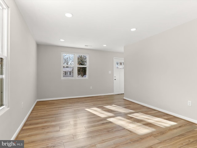 empty room with light hardwood / wood-style flooring