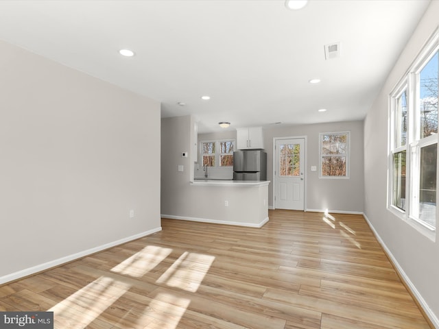 unfurnished living room featuring light hardwood / wood-style flooring