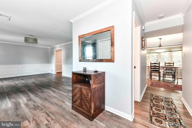 hallway with crown molding and hardwood / wood-style floors