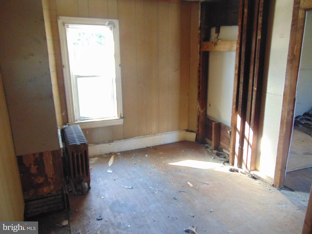 miscellaneous room featuring wooden walls and radiator