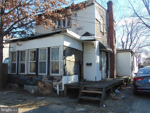 back of house with a deck