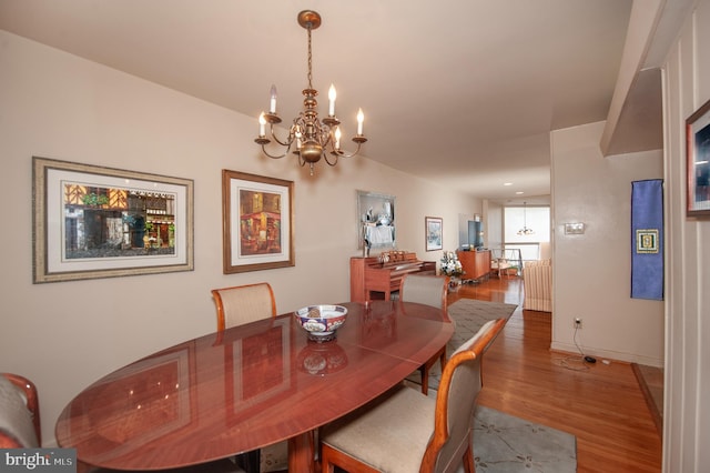 dining room featuring hardwood / wood-style floors and a chandelier