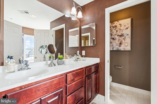 bathroom with vanity and toilet