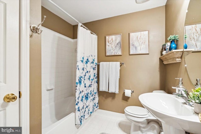 full bathroom featuring tile patterned flooring, sink, toilet, and shower / bath combo