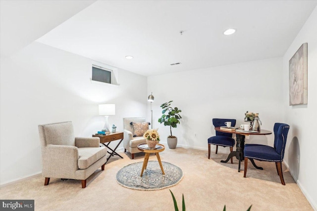 sitting room featuring light colored carpet