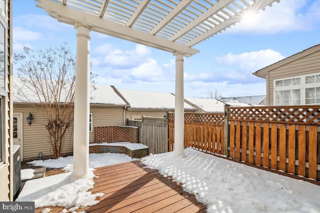 snow covered deck with a pergola