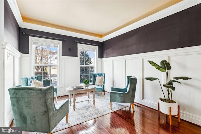 sitting room with hardwood / wood-style flooring