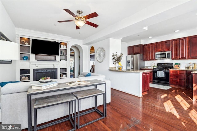 interior space featuring ceiling fan, dark hardwood / wood-style flooring, and built in features