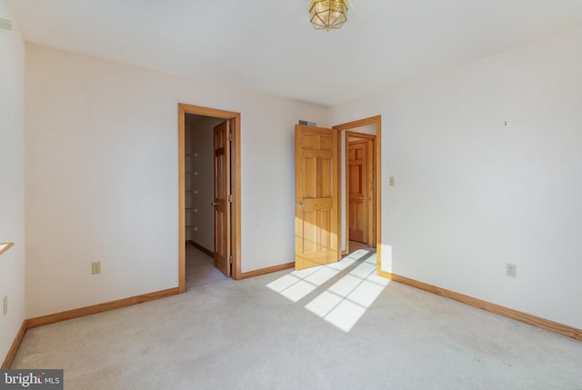 unfurnished bedroom featuring carpet and baseboards