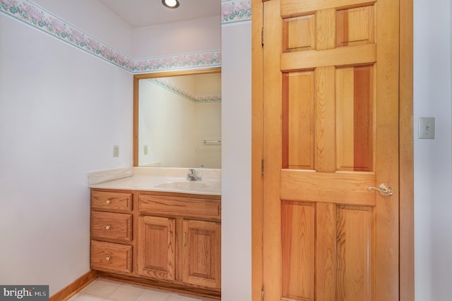 bathroom with baseboards and vanity