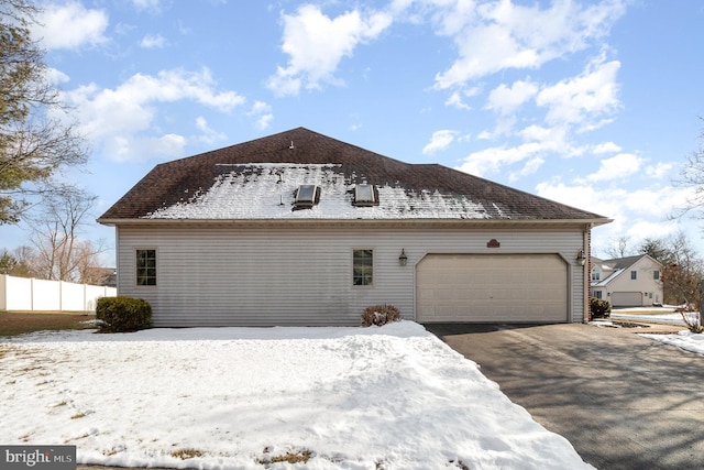 view of snow covered exterior with fence