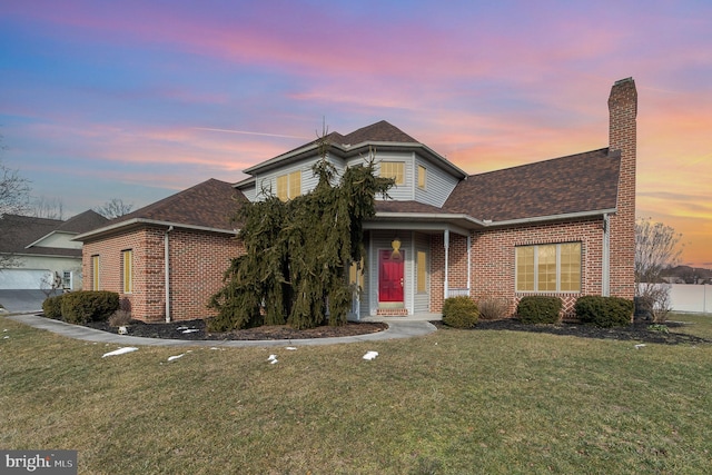 traditional home featuring roof with shingles, a chimney, a front lawn, and brick siding